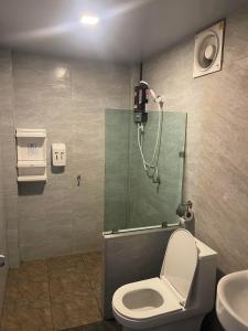a bathroom with a shower with a toilet and a sink at พบรักรีสอร์ท Pobruk resort in Tha Bo