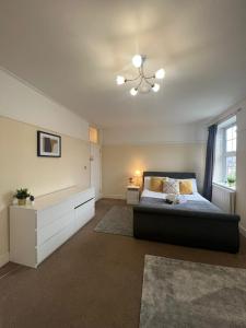 a bedroom with a large bed and a window at Stunning Wembley Stadium Flat in London +18 photos