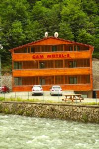 a building with cars parked in front of it at Cam Hotel & Restaurant 2 in Uzungöl