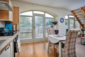 a kitchen and dining room with a table and chairs at Finest Retreats - Victory Mill - Apartment Five in Pickering