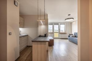 a kitchen with a island in the middle of a room at 18 Gdynia Centrum - Apartament Mieszkanie dla 4 os in Gdynia