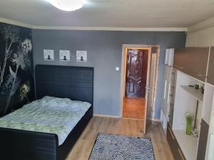 a small bedroom with a bed and a door at Oscar's Central Apartment in Timişoara