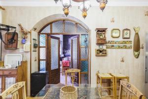 a kitchen and dining room with a table and chairs at CORTIJO EL LLANO GRAND in Almería