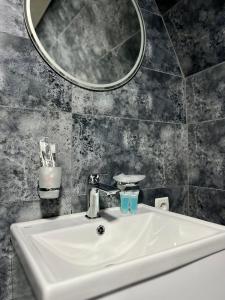 a white sink in a bathroom with a mirror at Cottage Carpe Diem in Stepantsminda