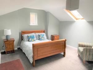 a bedroom with a bed with blue pillows on it at Lovely Victorian House near Liverpool Centre in Liverpool