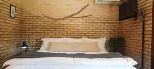 Un pat sau paturi într-o cameră la Solar Maria Carolina