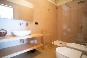 a bathroom with a sink and a toilet and a shower at Isola Verde in Casal Velino