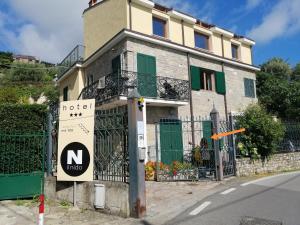 a building with a sign in front of it at Apartments Tellaro in Tellaro