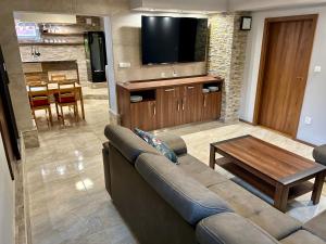 a living room with a couch and a table at Penzion U Golema Blansko in Blansko