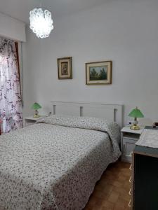 a bedroom with a bed and two tables with lamps at Appartamento al mare di Liguria e Toscana in Marina di Massa