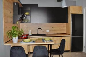 a kitchen with a table with chairs and a sink at Olive House in Golem +19 photos