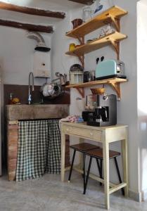 a kitchen with a table with a coffee maker on it at Casa Calma en Sierra de Vicort, Zaragoza in Inogés