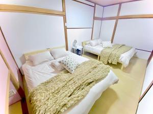 Ένα ή περισσότερα κρεβάτια σε δωμάτιο στο Eternity Marina HOUSE ONJUKU