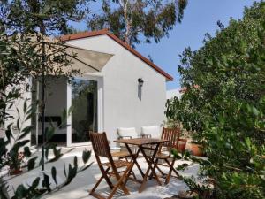 a patio with a table and chairs in front of a house at Quinta do Alento in Sesimbra