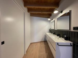 a bathroom with two sinks and a mirror at Manresa industrial home in Manresa