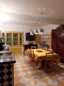 a kitchen with a table and chairs in a room at la Maison du Jardin in Marsillargues