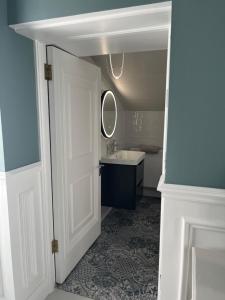 a white bathroom with a sink and a mirror at Kenilworth Square North in Dublin