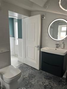 a bathroom with a toilet and a sink and a mirror at Kenilworth Square North in Dublin