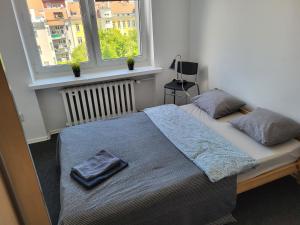 a bed in a bedroom with two pillows on it at Stilo Dom - ul Powstańców Śląskich in Wrocław