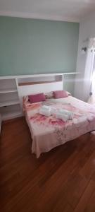 een slaapkamer met een bed met roze lakens en kussens bij Oasi in Poggio Moiano