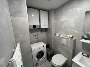 a small bathroom with a washing machine in it at Apartman Sara in Zenica