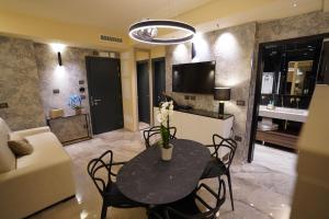 sala de estar con mesa negra y sillas en Ale Suite Sea Side View - Hotel Arizona, en Riccione