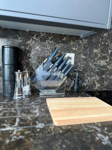 a kitchen counter with a cutting board and utensils at Cornwall - The Duke and Duchess in London