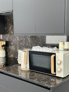 a microwave oven sitting on a counter in a kitchen at Cornwall - The Duke and Duchess in London
