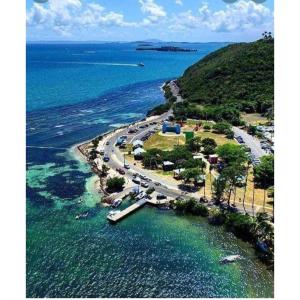 an aerial view of a beach next to the water at Cozy Cute Home 2nd floor in Fajardo