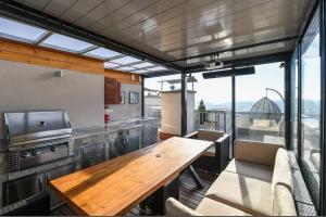 a kitchen with a wooden table in a room at Luxury rooftop appartment with fantastic views in Prague