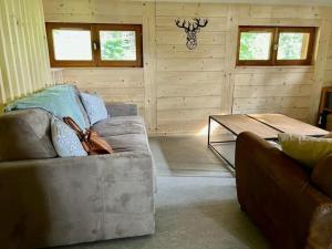 a living room with a couch and a coffee table at Chalet la parenthèse in Le Tholy