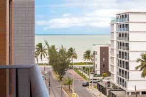 a view of the beach from the balcony of a building at Park Del Prado #603 - Intermares por Carpediem in Cabedelo