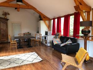 a living room with a couch and a table at Le Kiosque de Compostelle in Espaly-Saint-Marcel