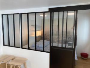 a room with a window with a view of a city at Arts & Métiers Nord Marais Studio 27m2 in Paris