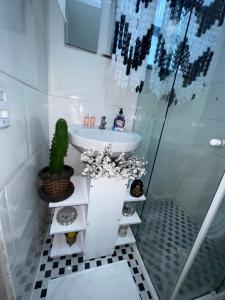 a bathroom with a sink and a shower at Studio Leblon in Rio de Janeiro