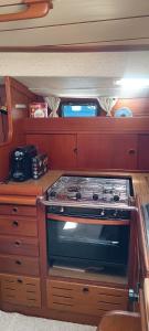 a kitchen with a stove in an rv at Your Sailing House Sardinia in San Teodoro