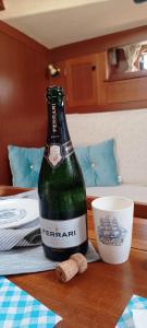 a bottle of beer sitting on top of a table at Your Sailing House Sardinia in San Teodoro