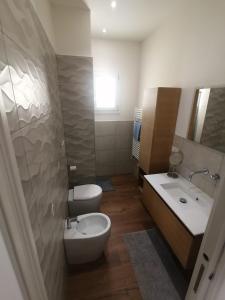 a bathroom with a toilet and a sink and a tub at 0541 Guest House Rimini in Rimini