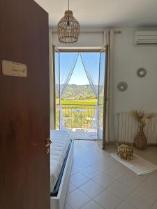 a room with a door to a balcony with a view at Vista sul Forte in Gavi