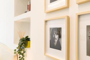 a picture frame on a wall with a picture of a man at Modern & Elegant by NDP Rent - NDP Rent in Rome