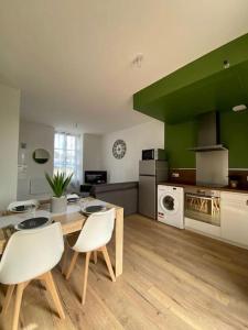 cocina con mesa y sillas en una habitación en LOFT Jardin et Spa, en Bressuire