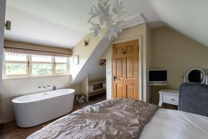 a bedroom with a bath tub and a bed at Esk View in Whitby