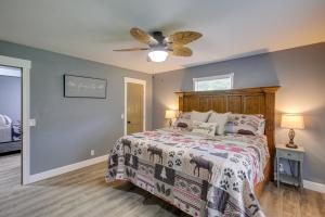 - une chambre avec un lit et un ventilateur de plafond dans l'établissement Serene Bryant Retreat with Private Hot Tub!, à Kimball