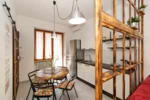 a kitchen with a table and chairs in a room at MM Pozzo Strada Lovely Aptartment in Turin