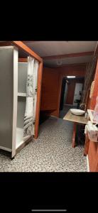 an empty kitchen with a refrigerator and a table at Erdei Buborék in Szarvaskő