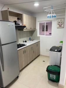 a kitchen with a refrigerator and a counter in it at Apartamento amoblado (Coveñas) in Coveñas