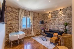 a living room with a brick wall at Riva - the heart of palace in Split