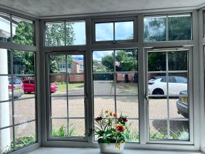 a window with a view of a parking lot at All Seasons Gatwick Guest House & Parking in Horley