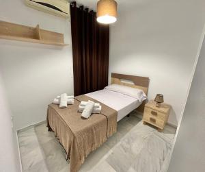 a bedroom with a bed and a table with a mirror at Doña Julia Golf in Casares