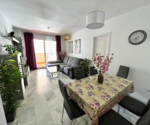 a living room with a table and a couch at Doña Julia Golf in Casares